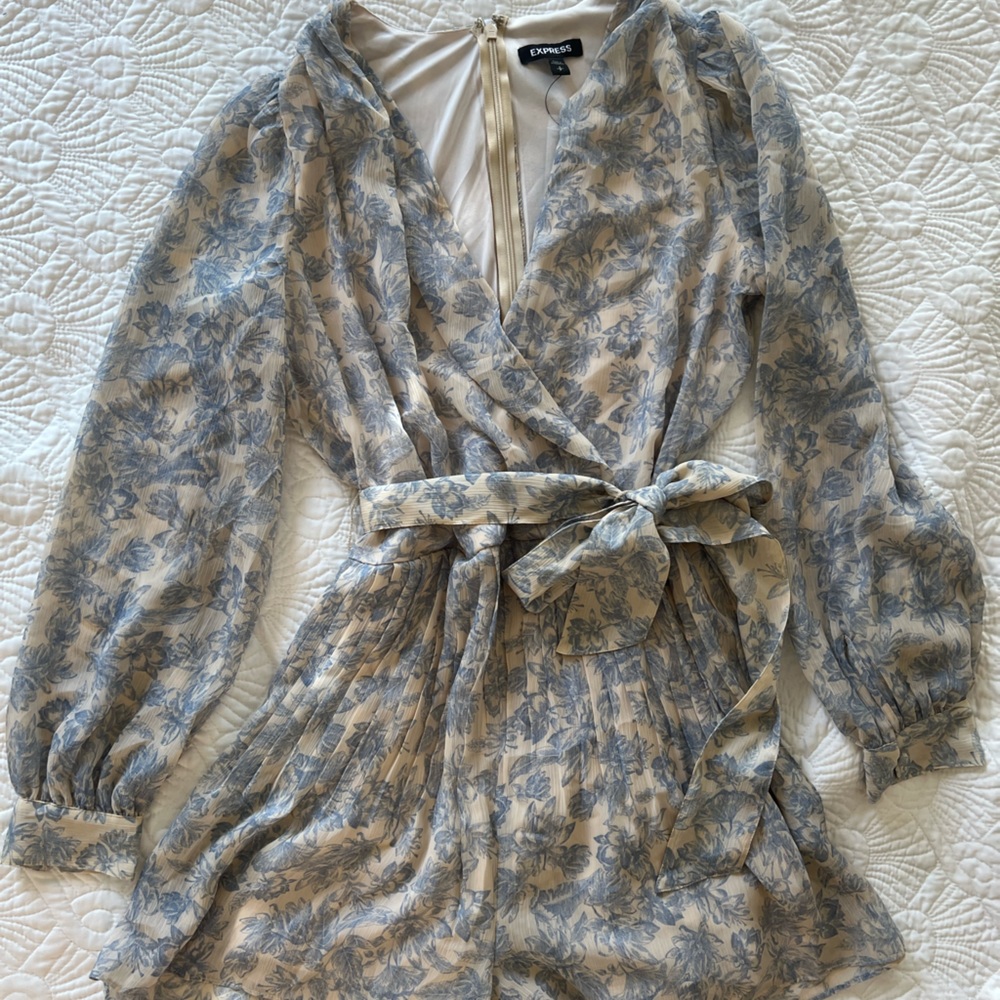 Blue and cream floral romper. Pleating detail and sash.